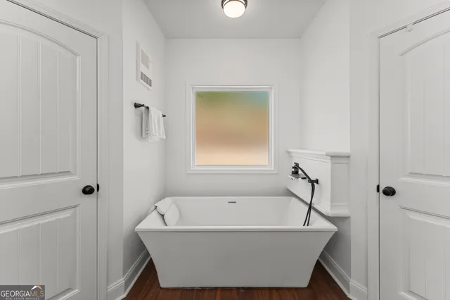 a bathroom with bathtub and shower