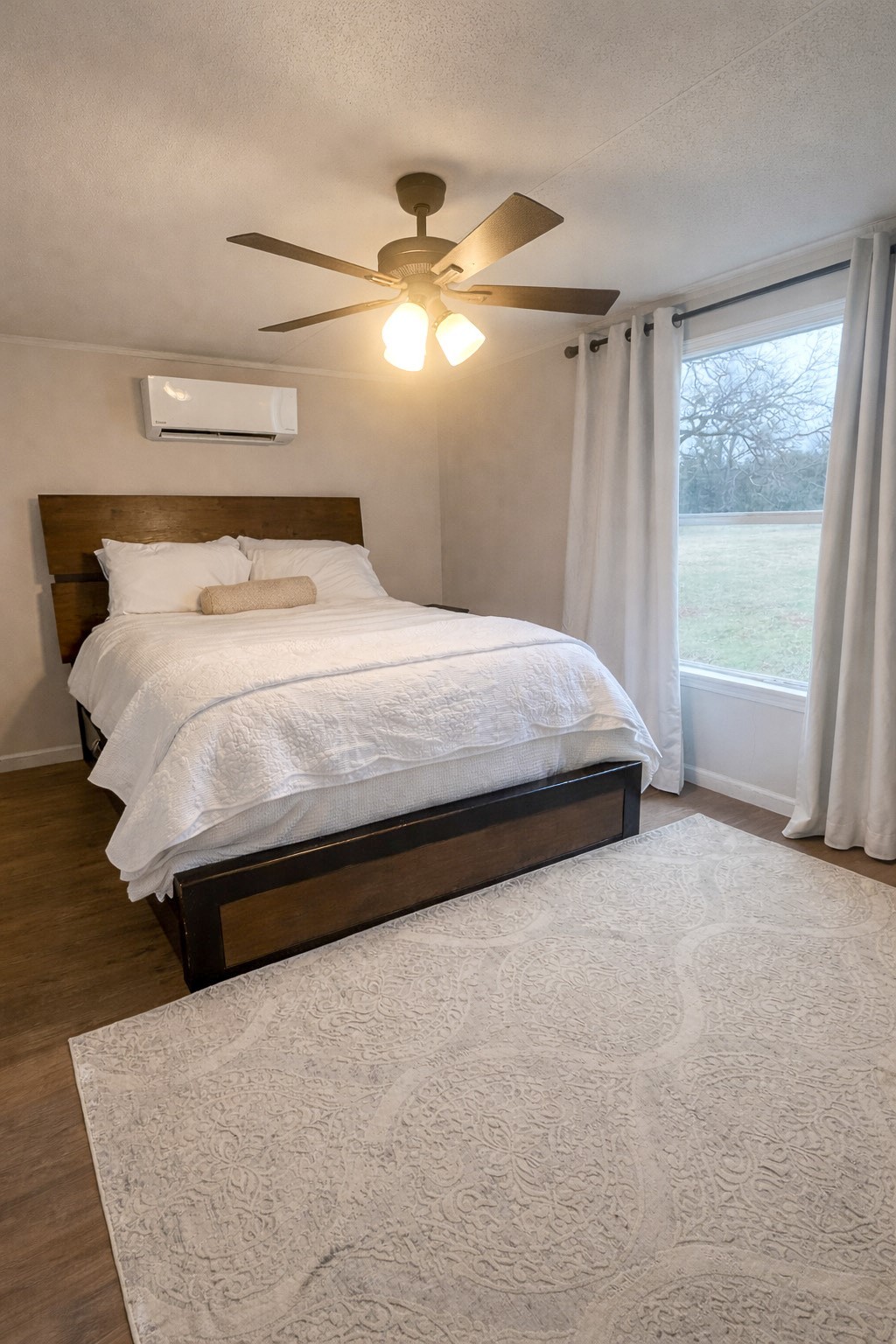 7031 Red Rock Road Franklin, TX 77856 - Photo 12 of 17 a large bed sitting in a bedroom next to a window