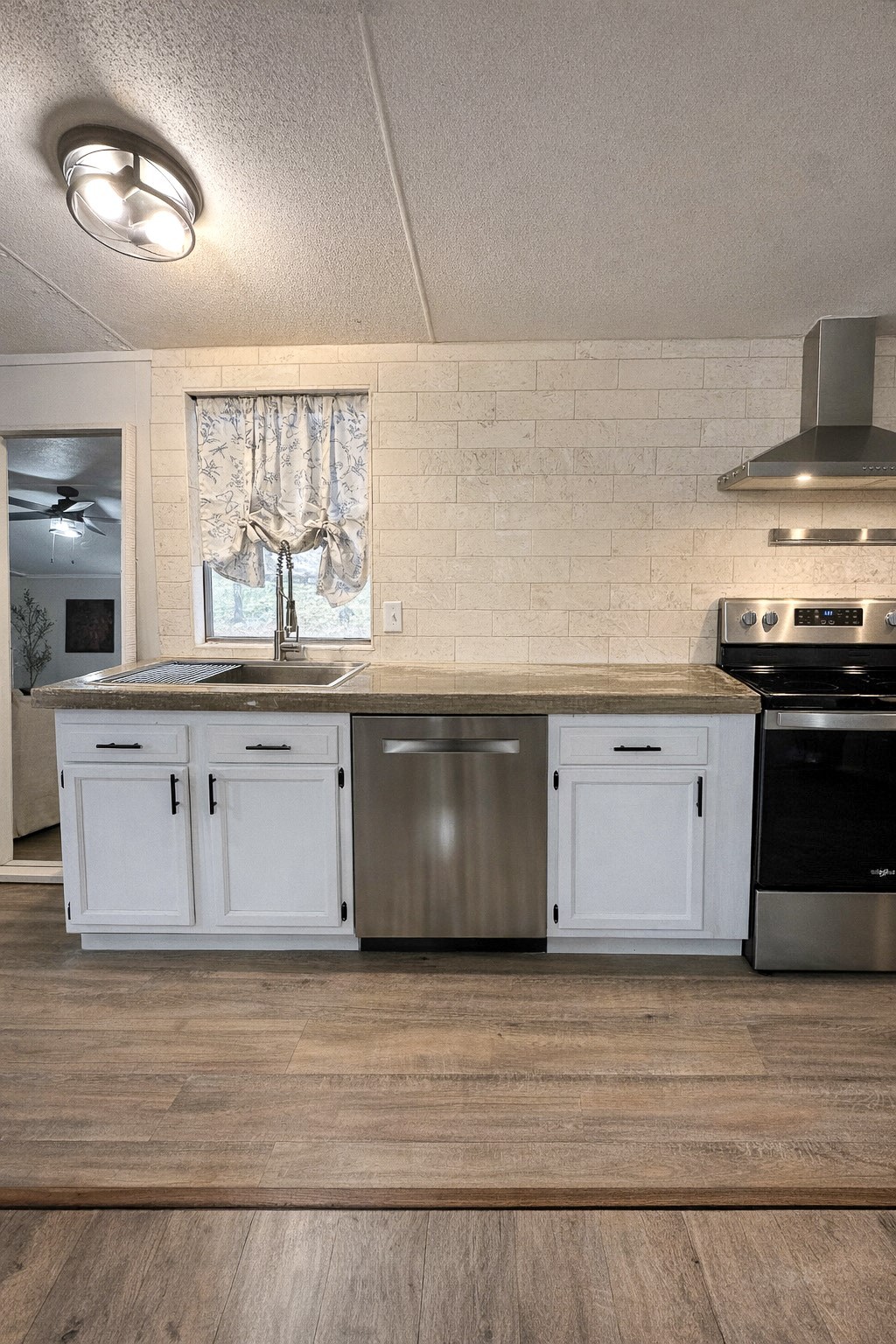 7031 Red Rock Road Franklin, TX 77856 - Photo 6 of 17 a large kitchen with stainless steel appliances granite countertop a stove a sink and a microwave