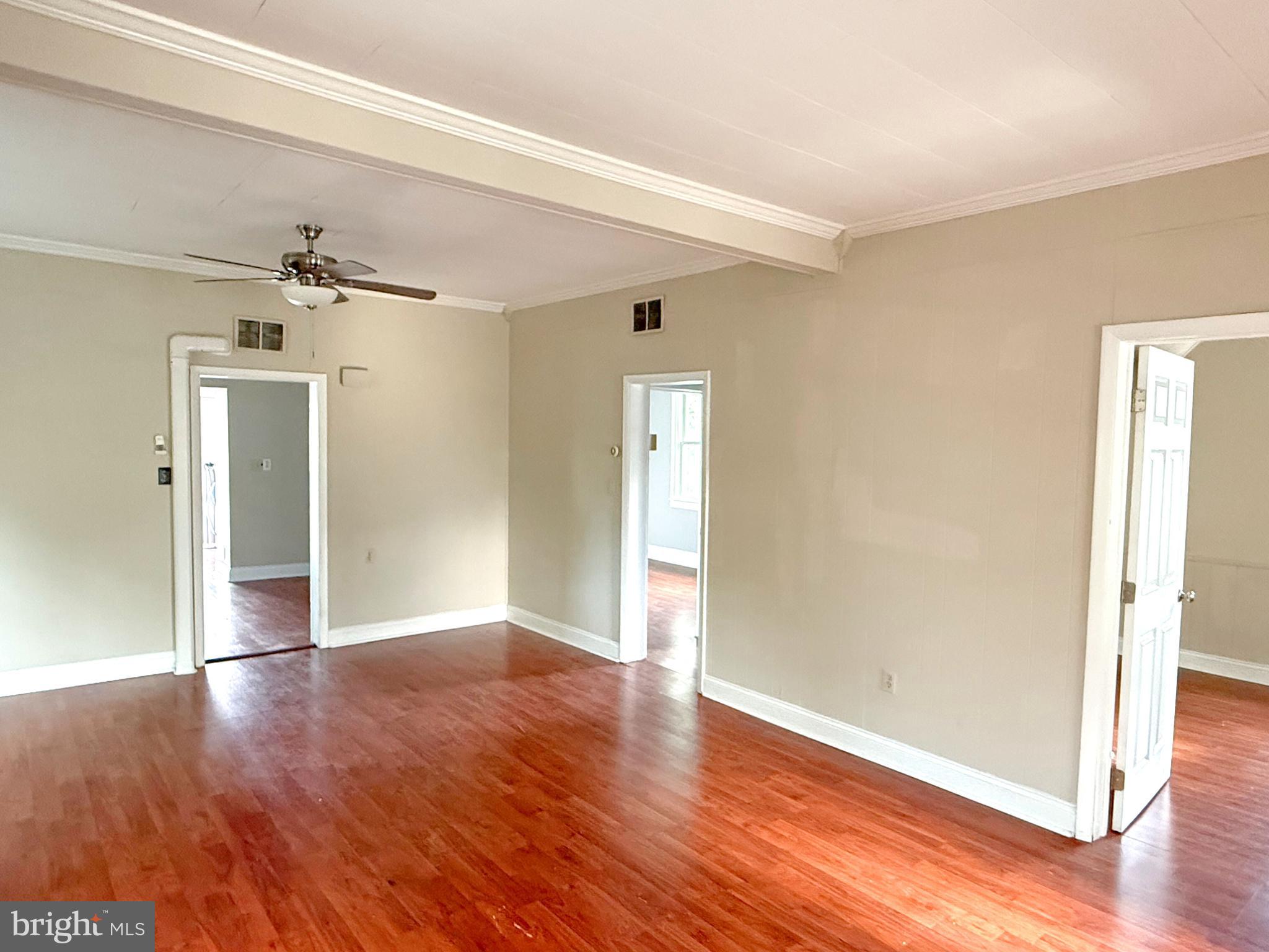 13579 Summit Avenue Blue Ridge Summit, PA 17214 - Photo 6 of 18 an empty room with wooden floor and a ceiling fan