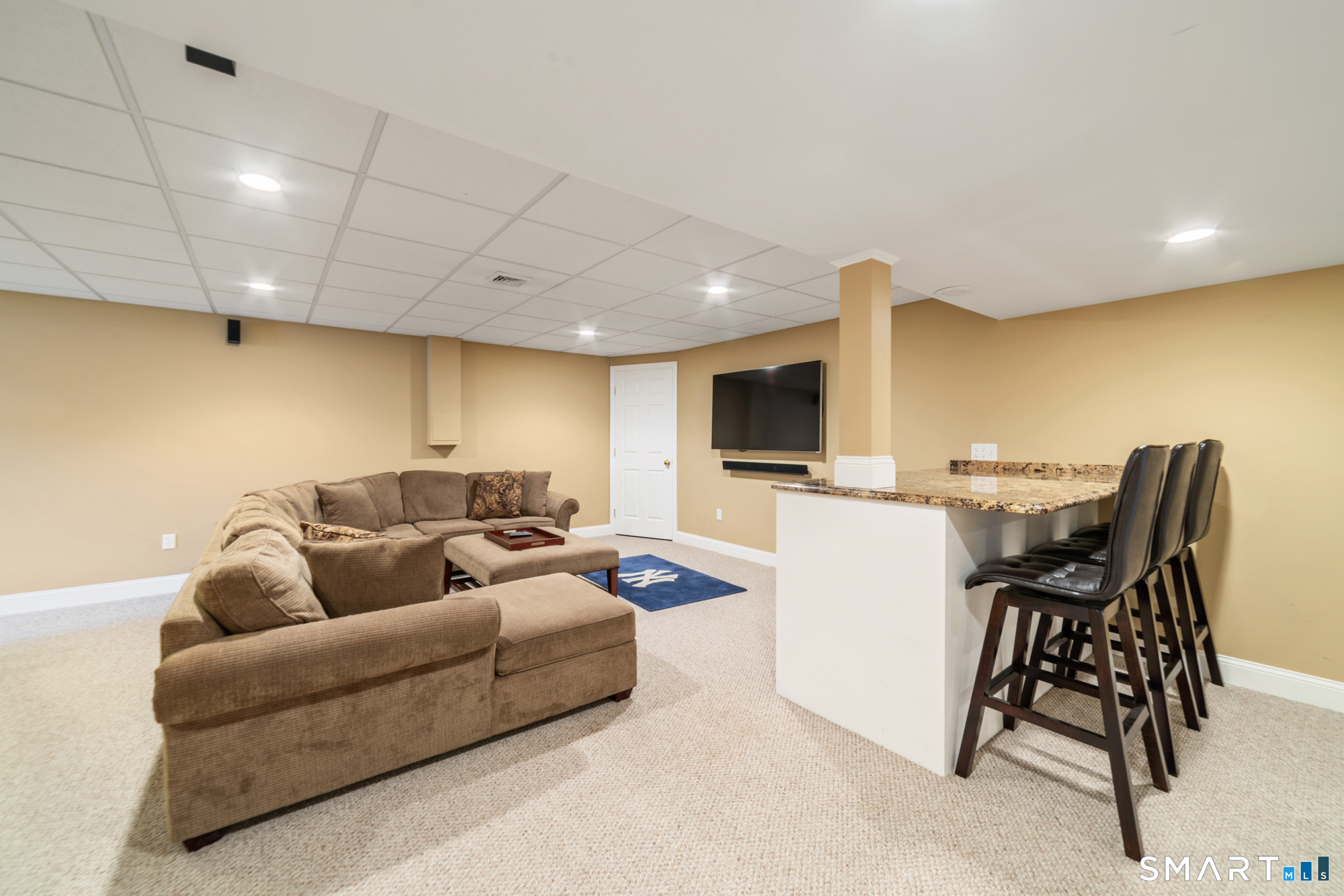 23 Mountain Pond Road Southington, CT 06489 - Photo 30 of 39 a living room with furniture and a flat screen tv
