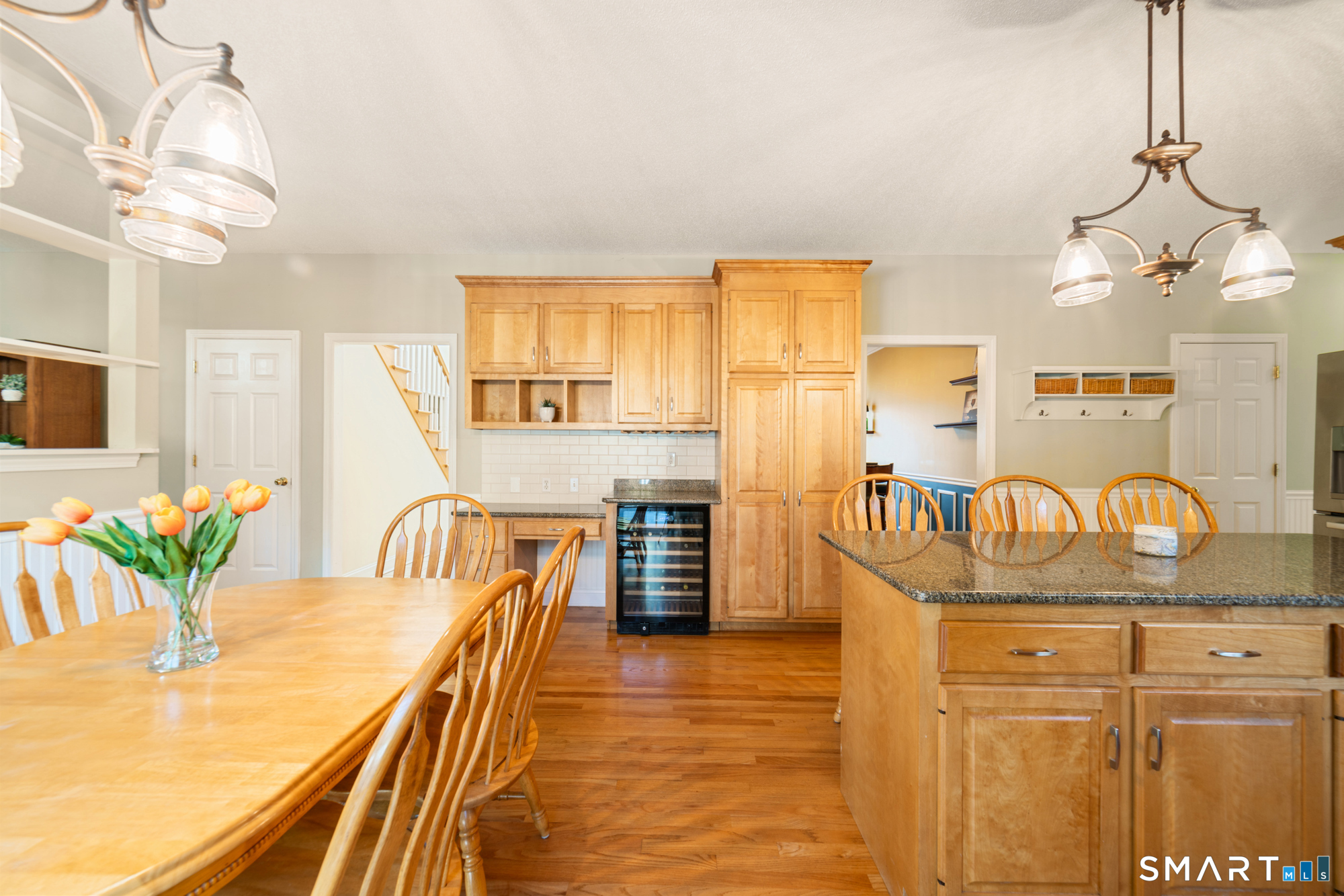 23 Mountain Pond Road Southington, CT 06489 - Photo 7 of 39 a kitchen with granite countertop a table chairs in it and wooden floors