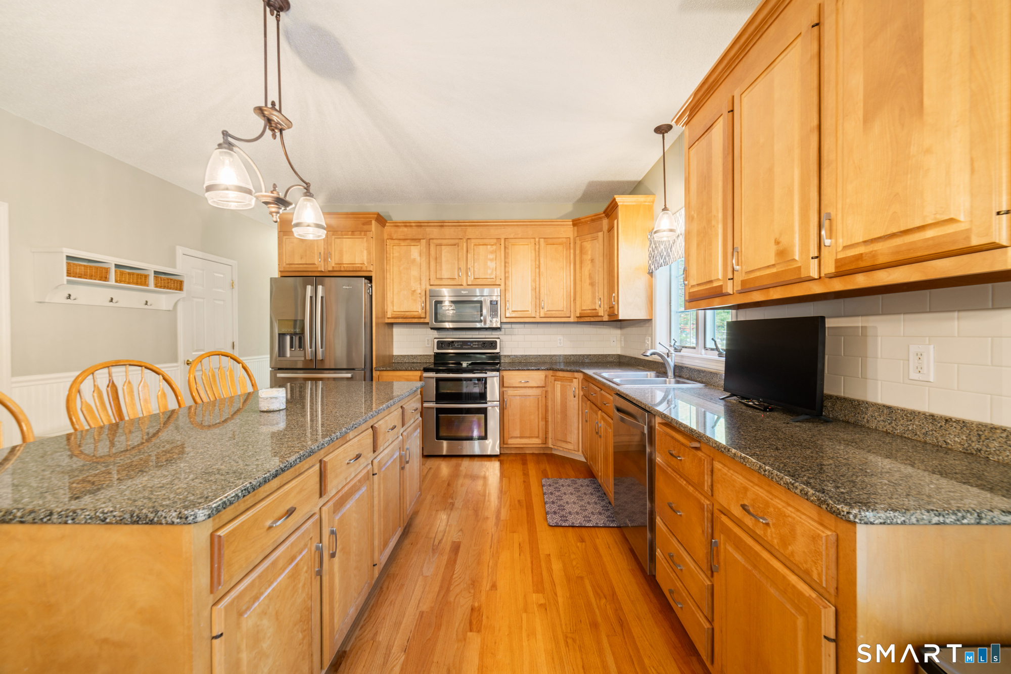 23 Mountain Pond Road Southington, CT 06489 - Photo 8 of 39 a kitchen with stainless steel appliances granite countertop a sink a stove and a wooden floors