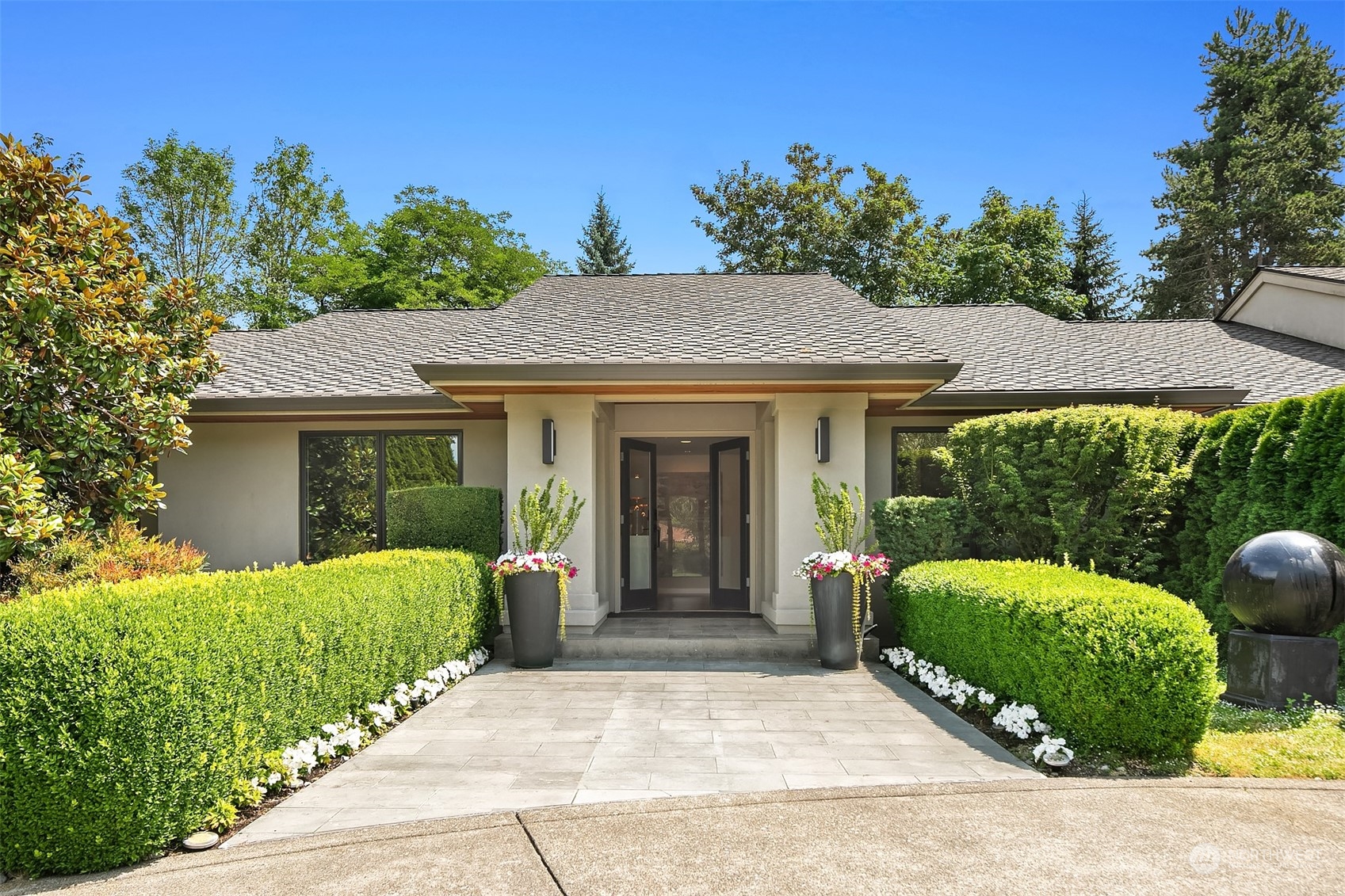 8541 Hunts Point Lane Hunts Point, WA 98004 - Photo 2 of 34 a front view of a house with garden