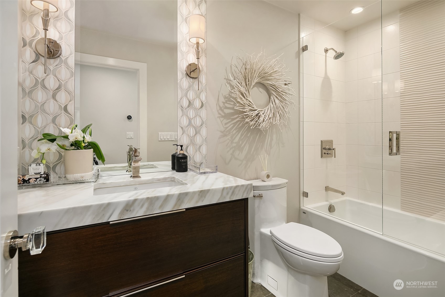 8541 Hunts Point Lane Hunts Point, WA 98004 - Photo 24 of 34 a bathroom with a sink a toilet and shower