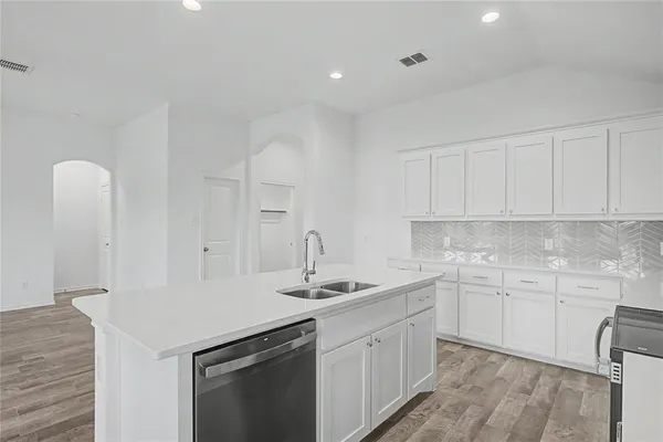a kitchen that has a sink and a stove in it