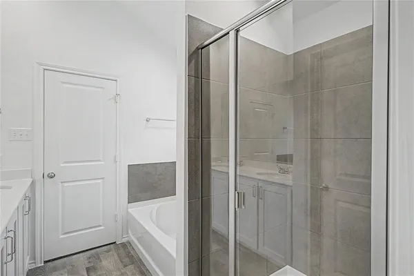 a bathroom with a bathtub and shower