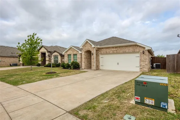 a view of a house with a yard and a garage