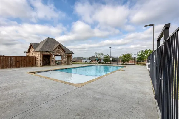 a view of swimming pool in front of house