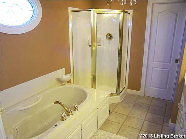 3530 Samuels Road Coxs Creek, KY 40013 - Photo 14 of 30 Master Suite Bath with french doors from the Master Suite, decorative Air/Jacuzzi tub, his and her sinks, lots of cabinets & space, separate shower, separate toilet area, ceramic tile floor, crown molding, recessed lighting, chandelier and a walk-in closet