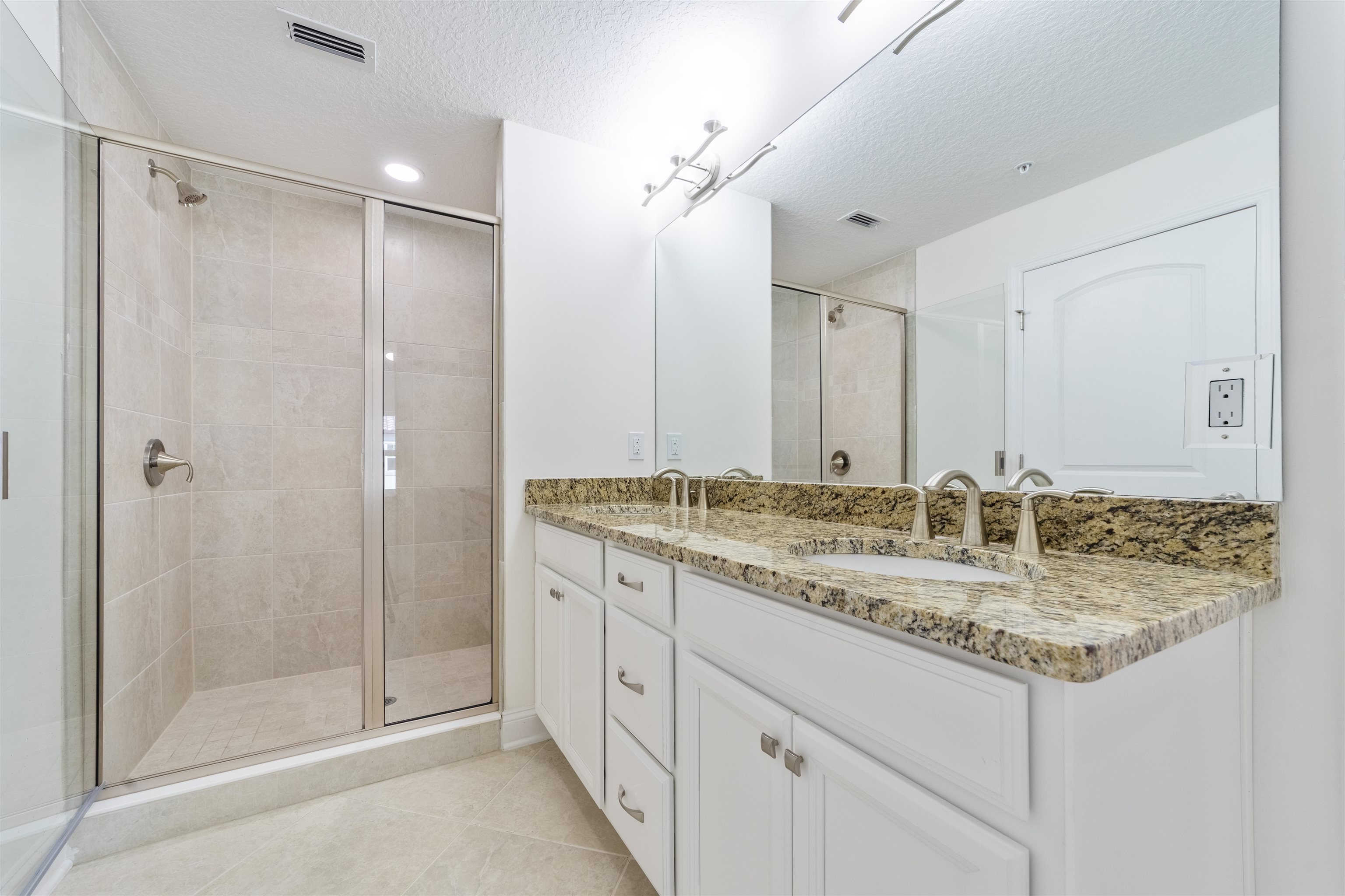 255 Grand Ravine Drive St. Augustine, FL 32086 - Photo 12 of 25 a bathroom with a granite countertop sink and a mirror