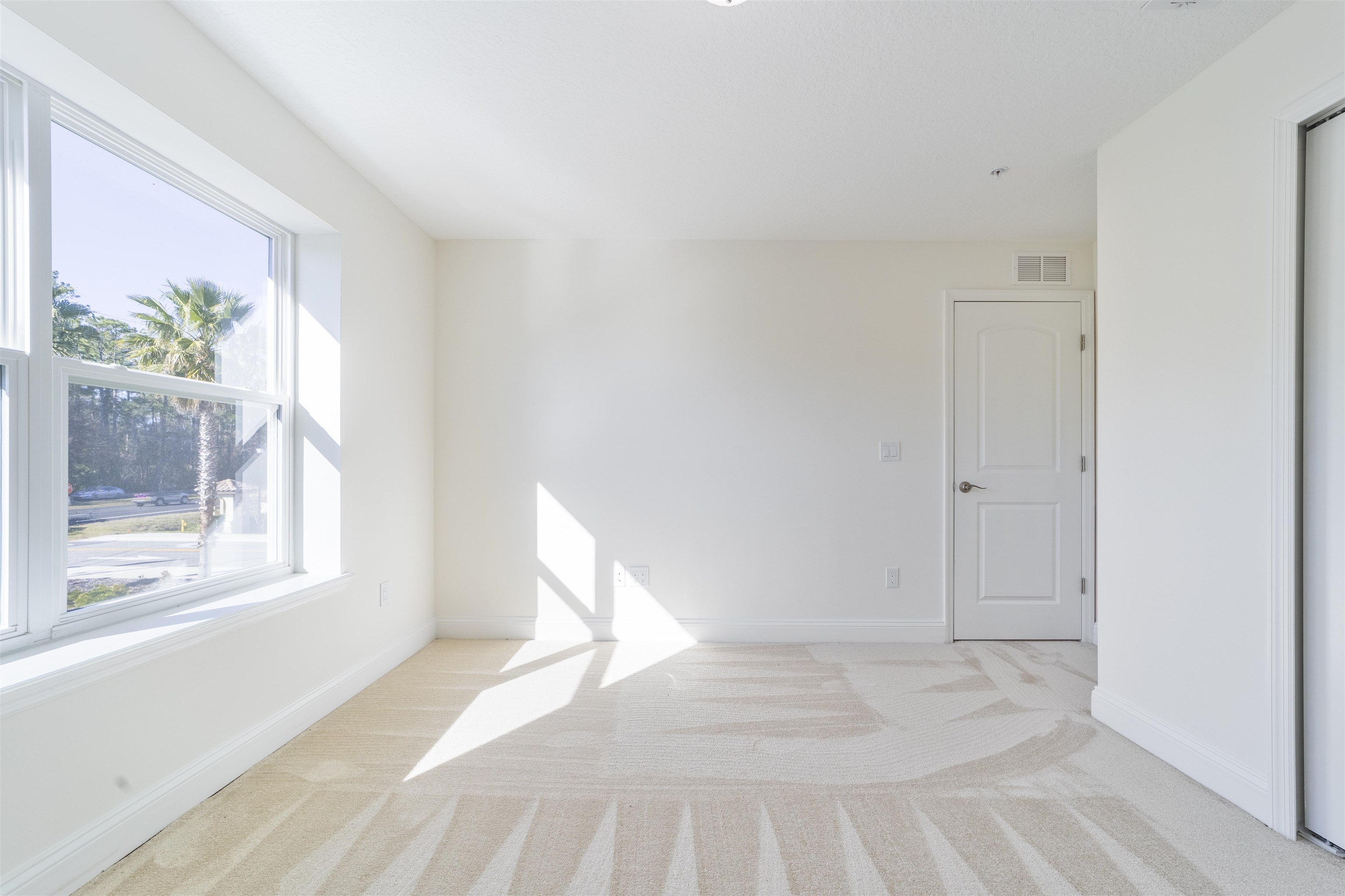 255 Grand Ravine Drive St. Augustine, FL 32086 - Photo 14 of 25 a view of a bedroom with a bed and a window