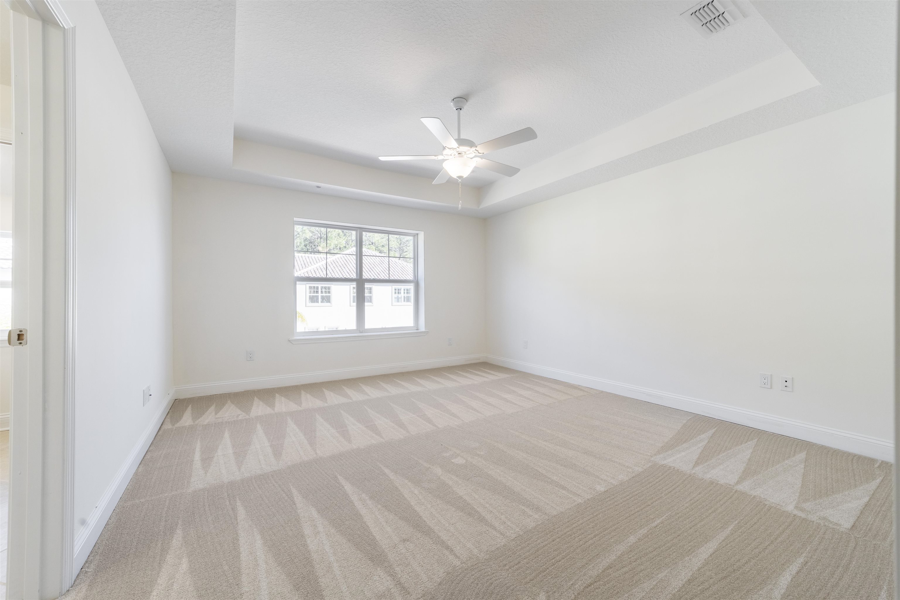 255 Grand Ravine Drive St. Augustine, FL 32086 - Photo 16 of 25 an empty room with windows and ceiling fan