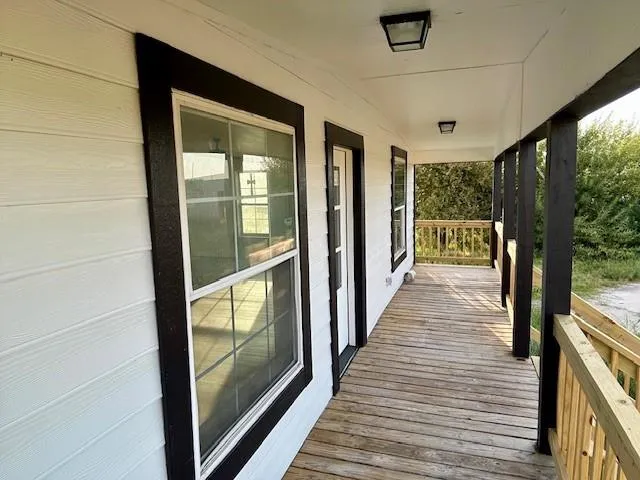 a view of a porch with wooden floor and stairs