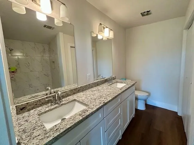 a kitchen with stainless steel appliances granite countertop a sink stove and cabinets