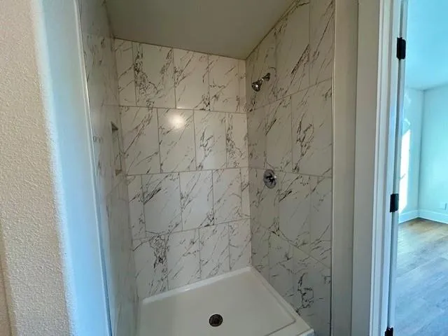 a bathroom with a granite countertop sink a toilet and a mirror