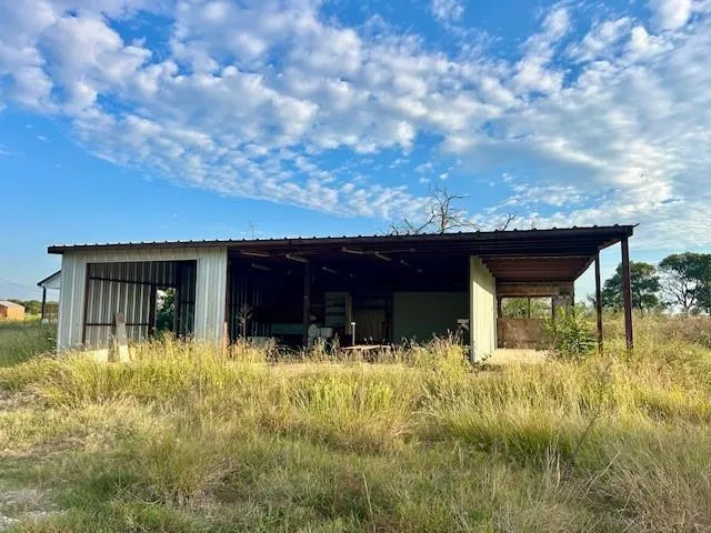 a view of house with yard and garage