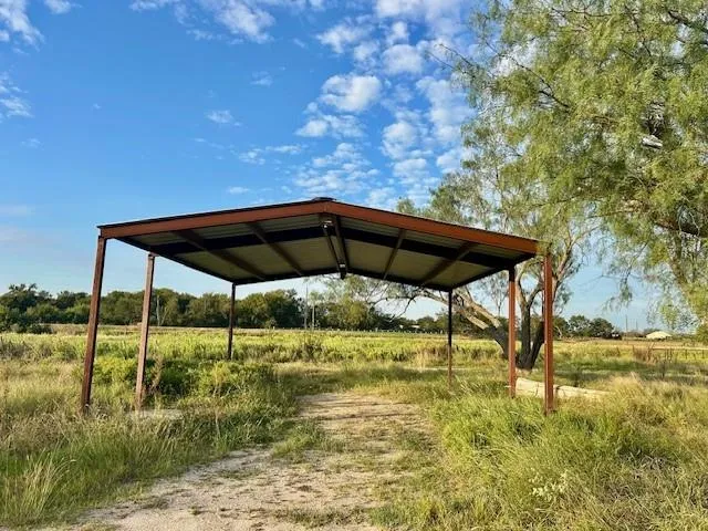 a view of lawn chairs under an umbrella