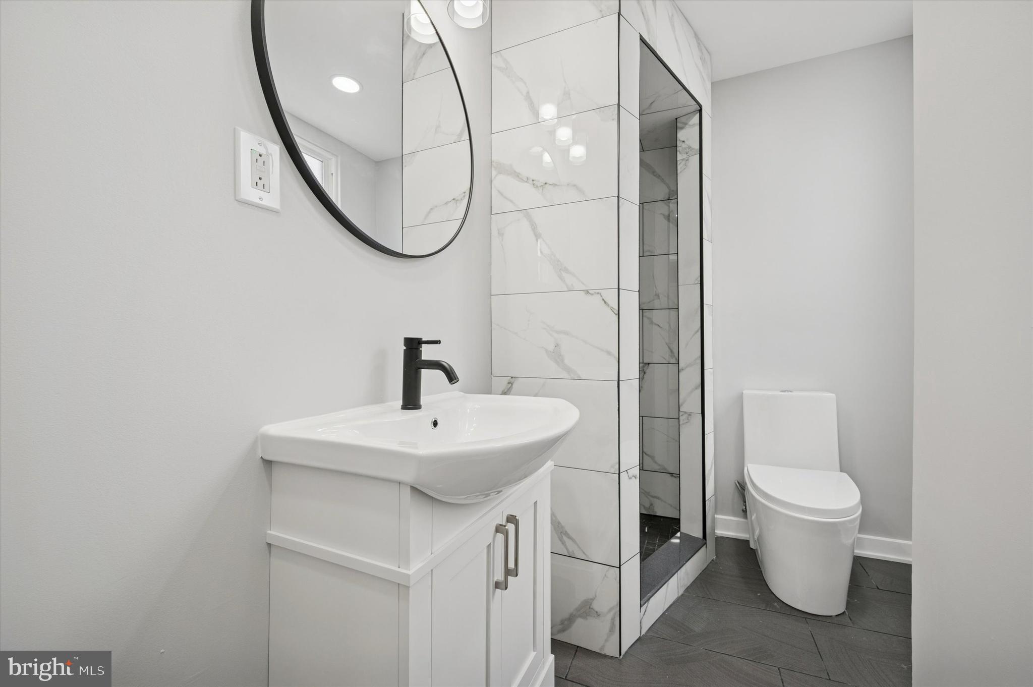 6866 North 19th Street Philadelphia, PA 19126 - Photo 16 of 28 a bathroom with a sink a toilet and a mirror
