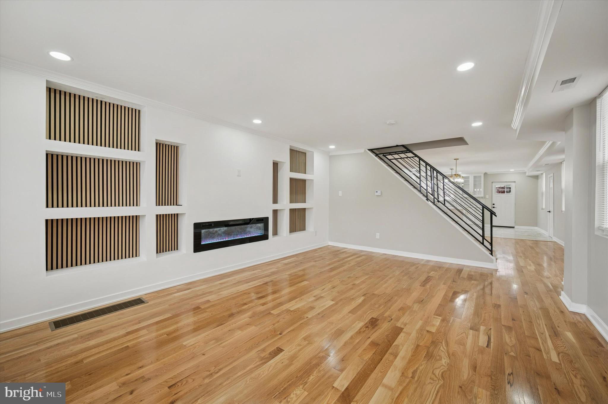 6866 North 19th Street Philadelphia, PA 19126 - Photo 7 of 28 a view of an empty room with wooden floor and a kitchen