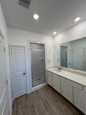 a bathroom with a double vanity sink and mirror