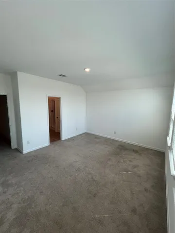 a spacious bathroom with a granite countertop sink toilet and a mirror