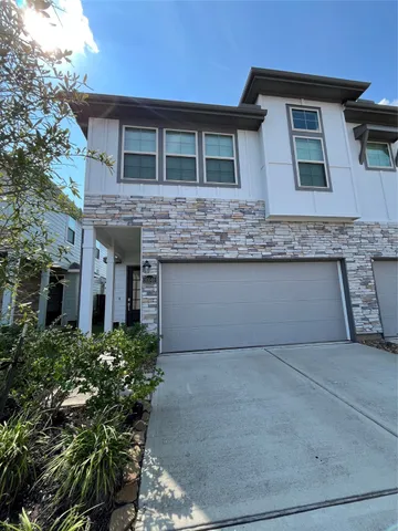 a front view of house with yard and trees around