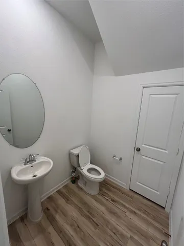 a bathroom with a sink toilet and mirror