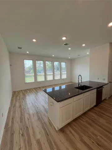 a kitchen with stainless steel appliances granite countertop a sink and window