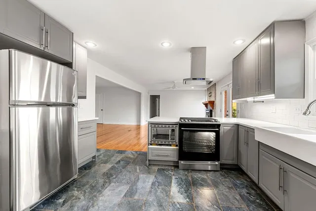 a kitchen with a stove and a refrigerator