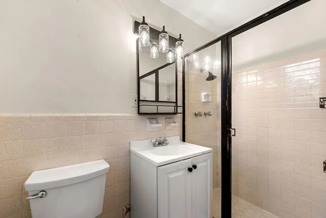 a bathroom with a toilet sink and mirror