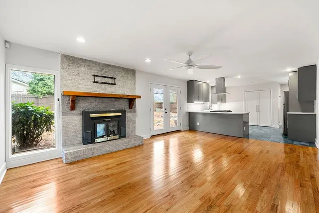 a view of kitchen with wooden floor and a fireplace