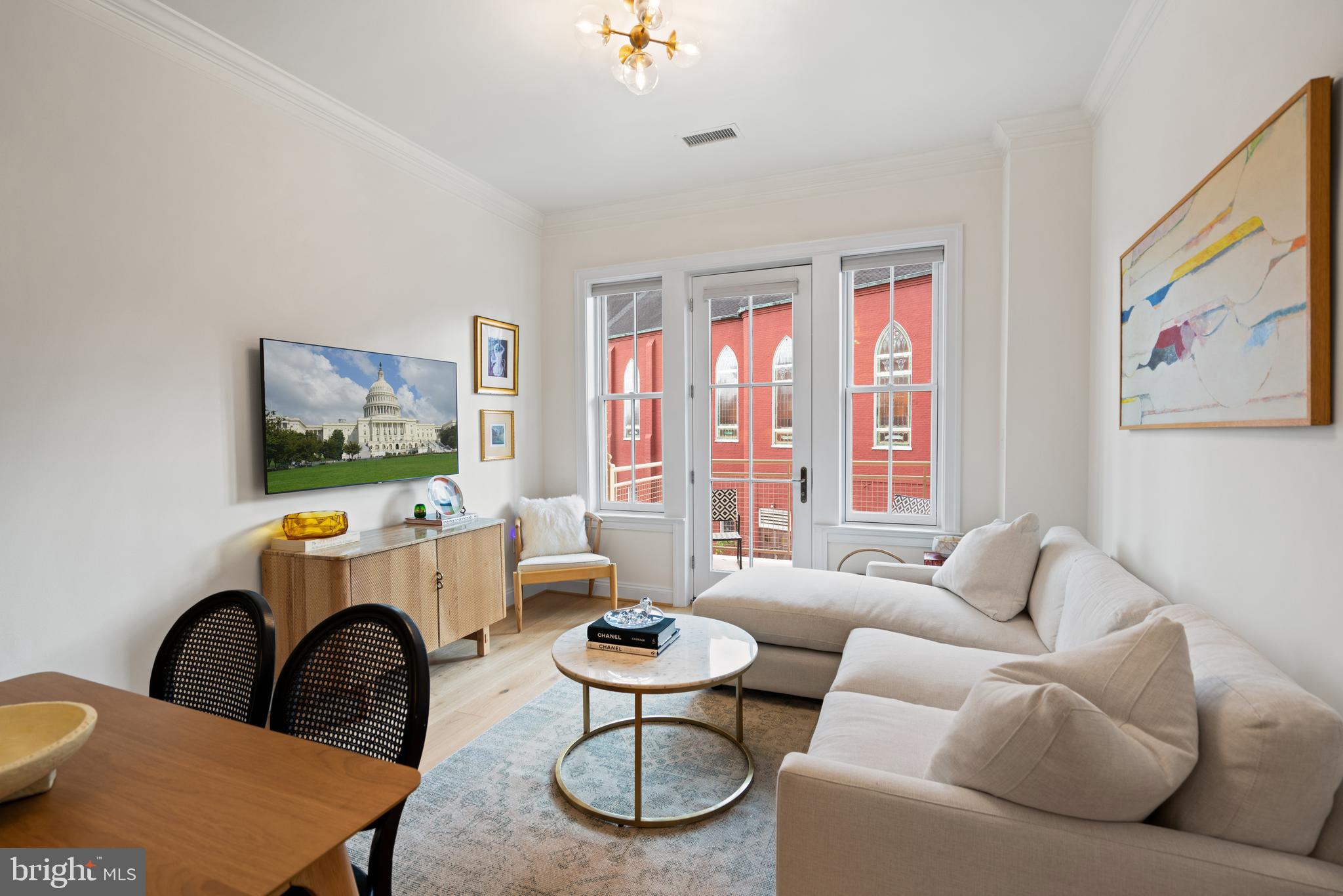 1210 R Street Northwest, Unit 213 Washington, DC 20009 - Photo 5 of 14 a living room with furniture and a large window