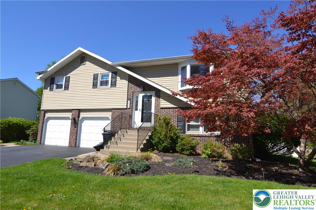 3071 Athena Drive Bethlehem, PA 18017 - Photo 1 of 27 a front view of a house with a garden and plants