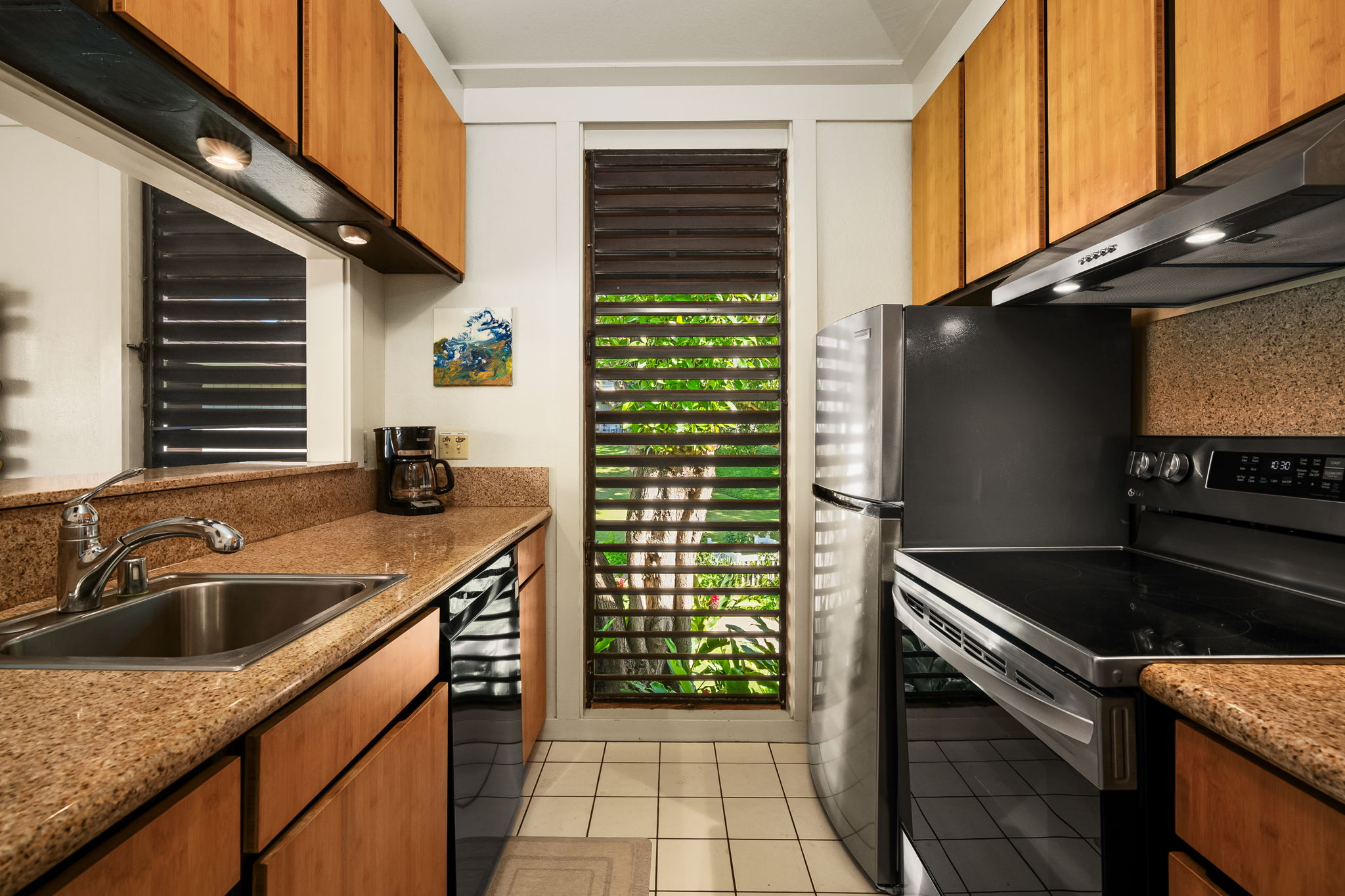 2253 Poipu Road, Unit 55 Koloa, HI 96756 - Photo 12 of 21 a kitchen that has a sink and a stove