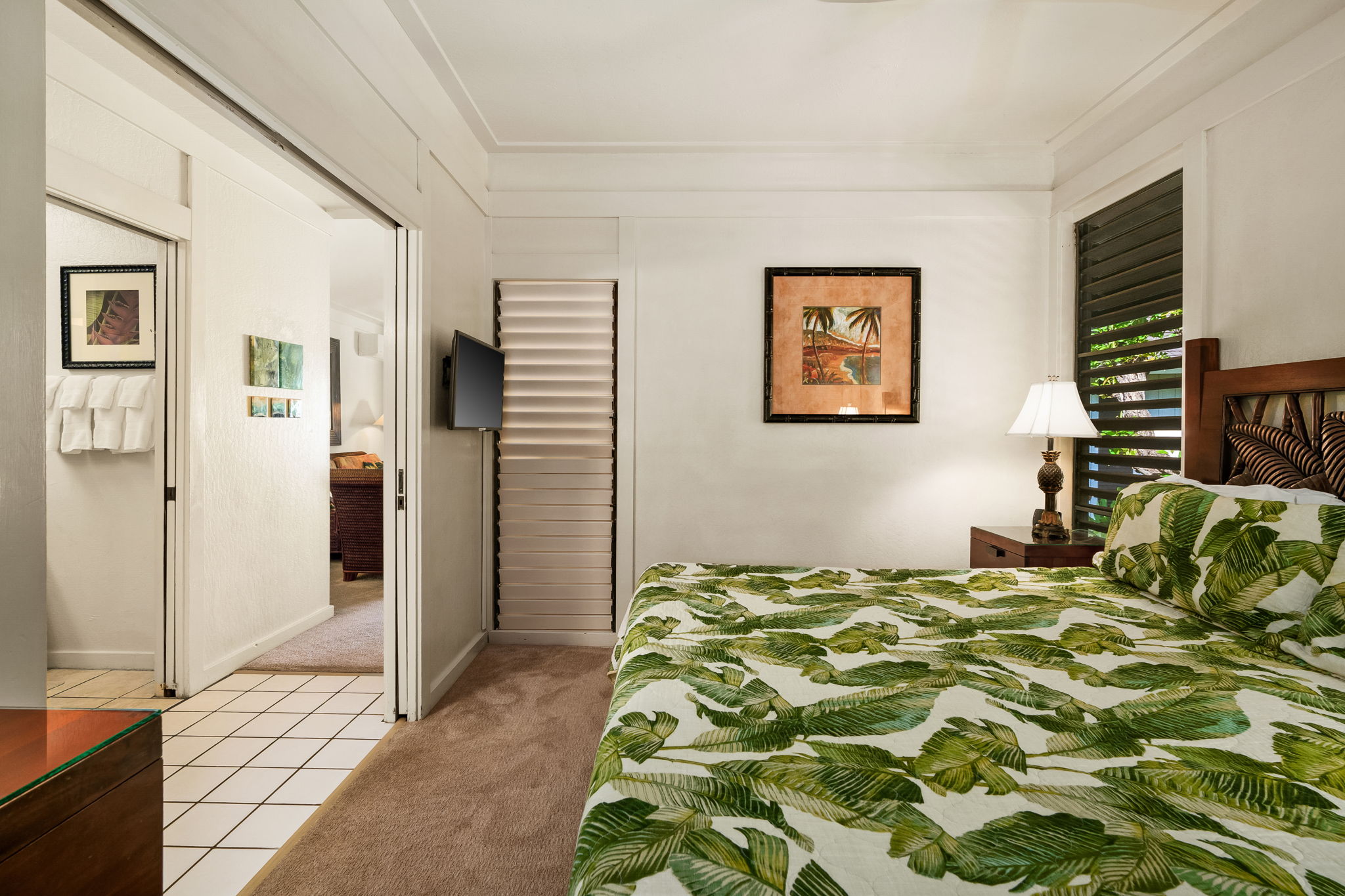 2253 Poipu Road, Unit 55 Koloa, HI 96756 - Photo 14 of 21 a bedroom with a bed and a view of bathroom