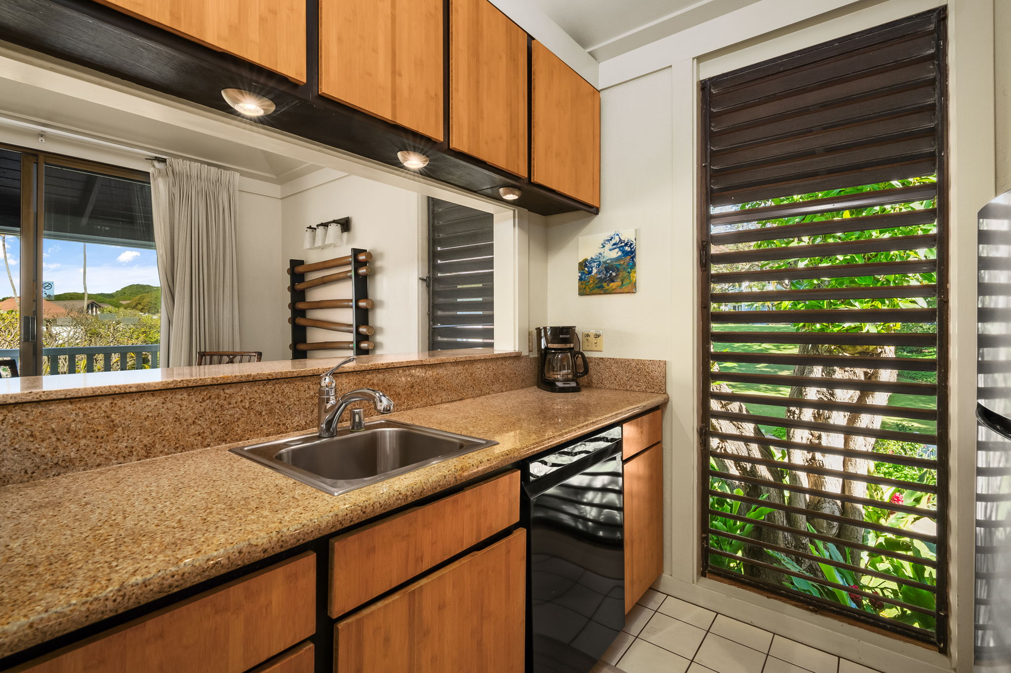 2253 Poipu Road, Unit 55 Koloa, HI 96756 - Photo 3 of 21 a kitchen with a sink and cabinets