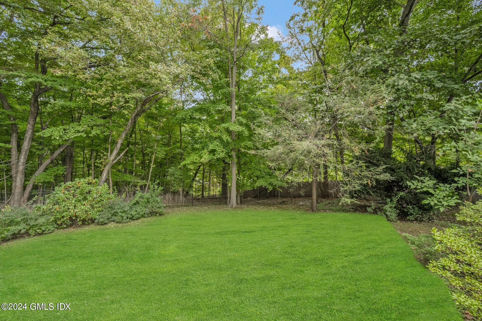 75 Bowman Drive Greenwich, CT 06831 - Photo 21 of 22 a view of a green field with a tree
