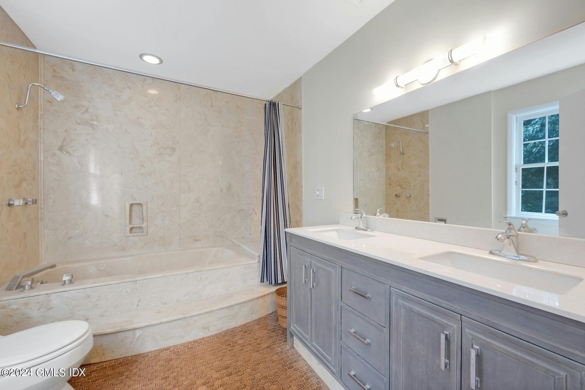 75 Bowman Drive Greenwich, CT 06831 - Photo 9 of 22 a bathroom with a granite countertop sink a toilet and shower