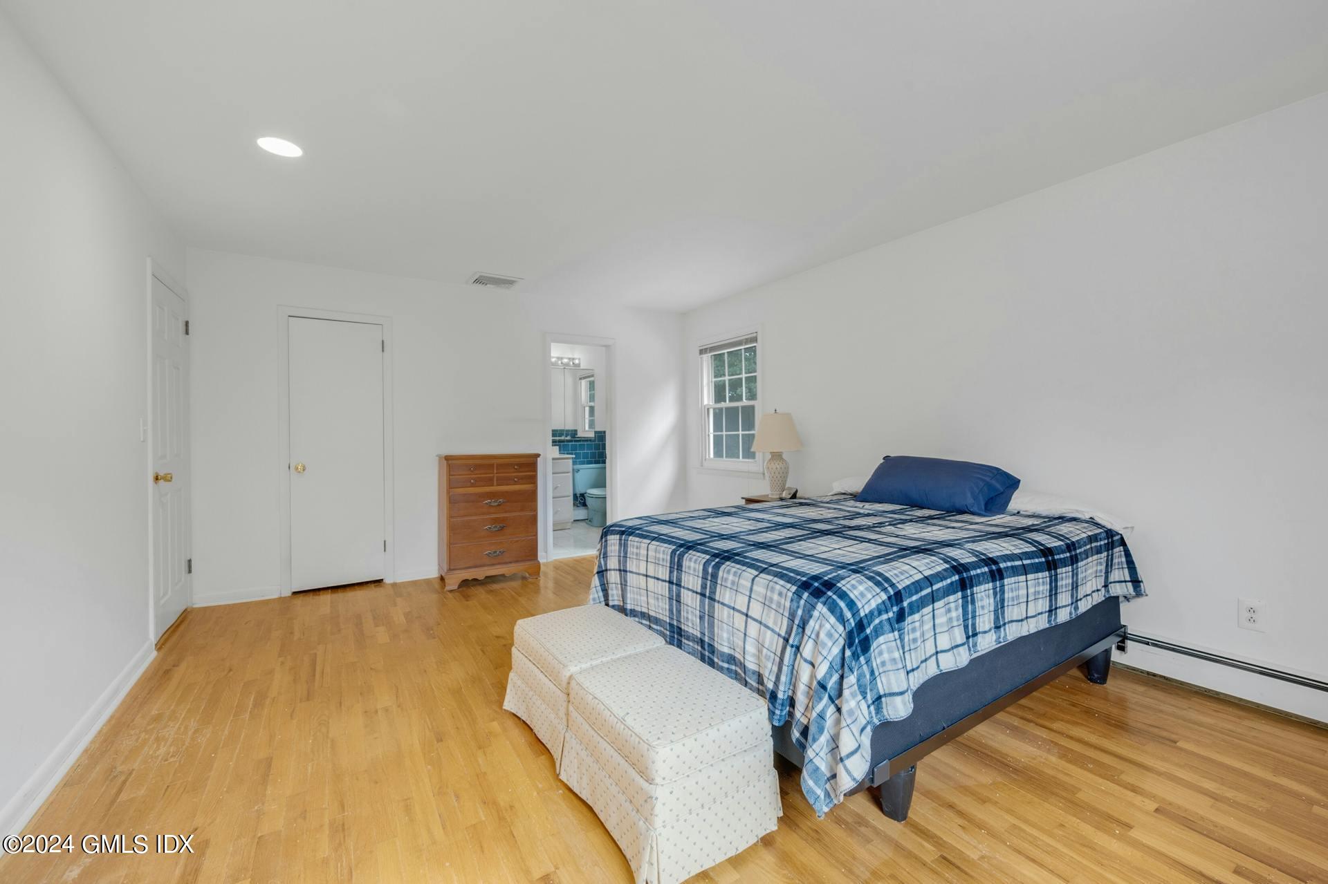 75 Bowman Drive Greenwich, CT 06831 - Photo 10 of 22 a bedroom with a bed and wooden floor