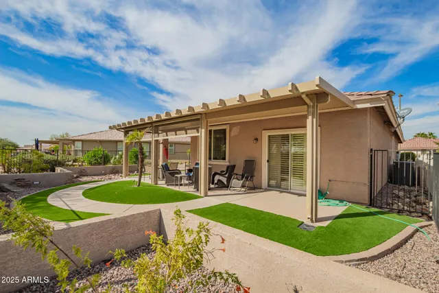 a front view of a house with swimming pool garden and patio