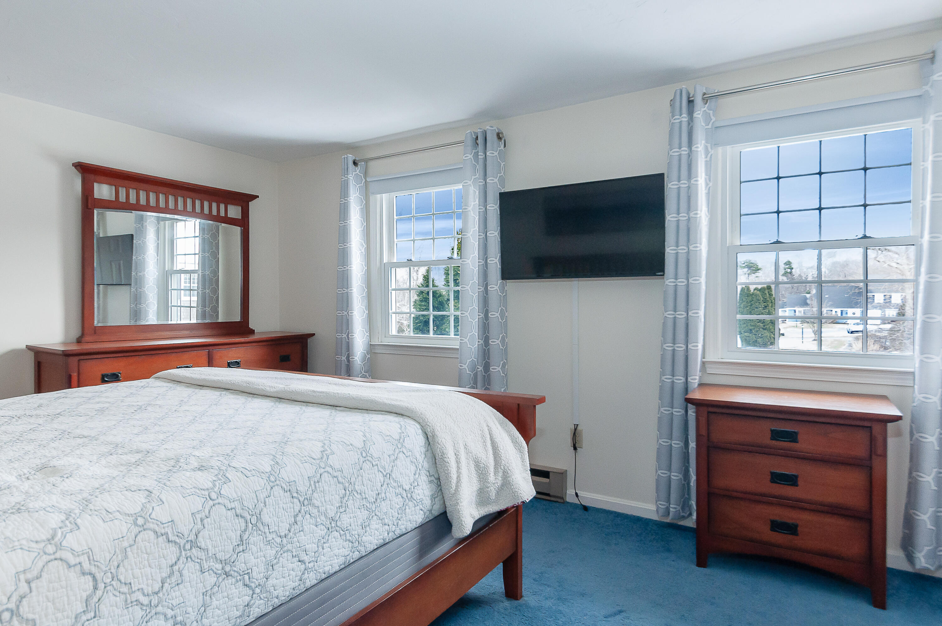36 Atkins Road, Unit E6 East Sandwich, MA 02537 - Photo 13 of 30 a bedroom with a bed and a flat screen tv