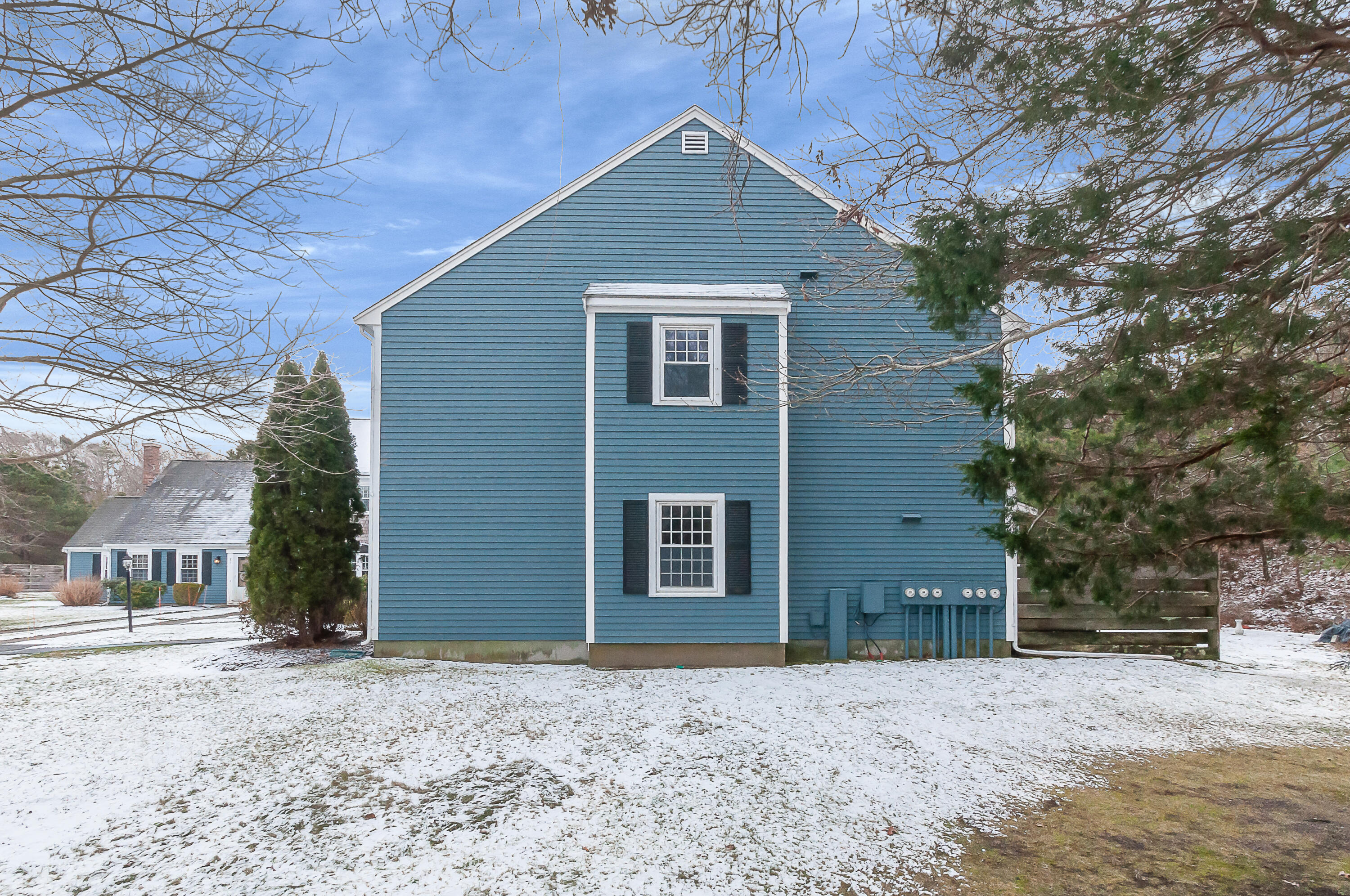 36 Atkins Road, Unit E6 East Sandwich, MA 02537 - Photo 20 of 30 a front view of a house with a yard and garage
