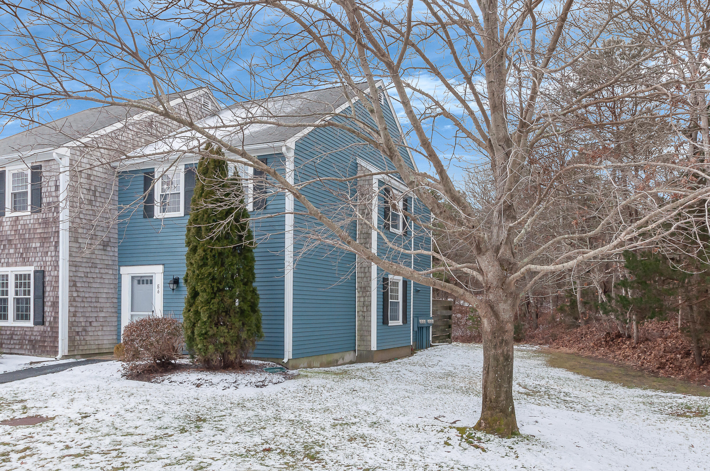 36 Atkins Road, Unit E6 East Sandwich, MA 02537 - Photo 21 of 30 a front view of a house with a yard