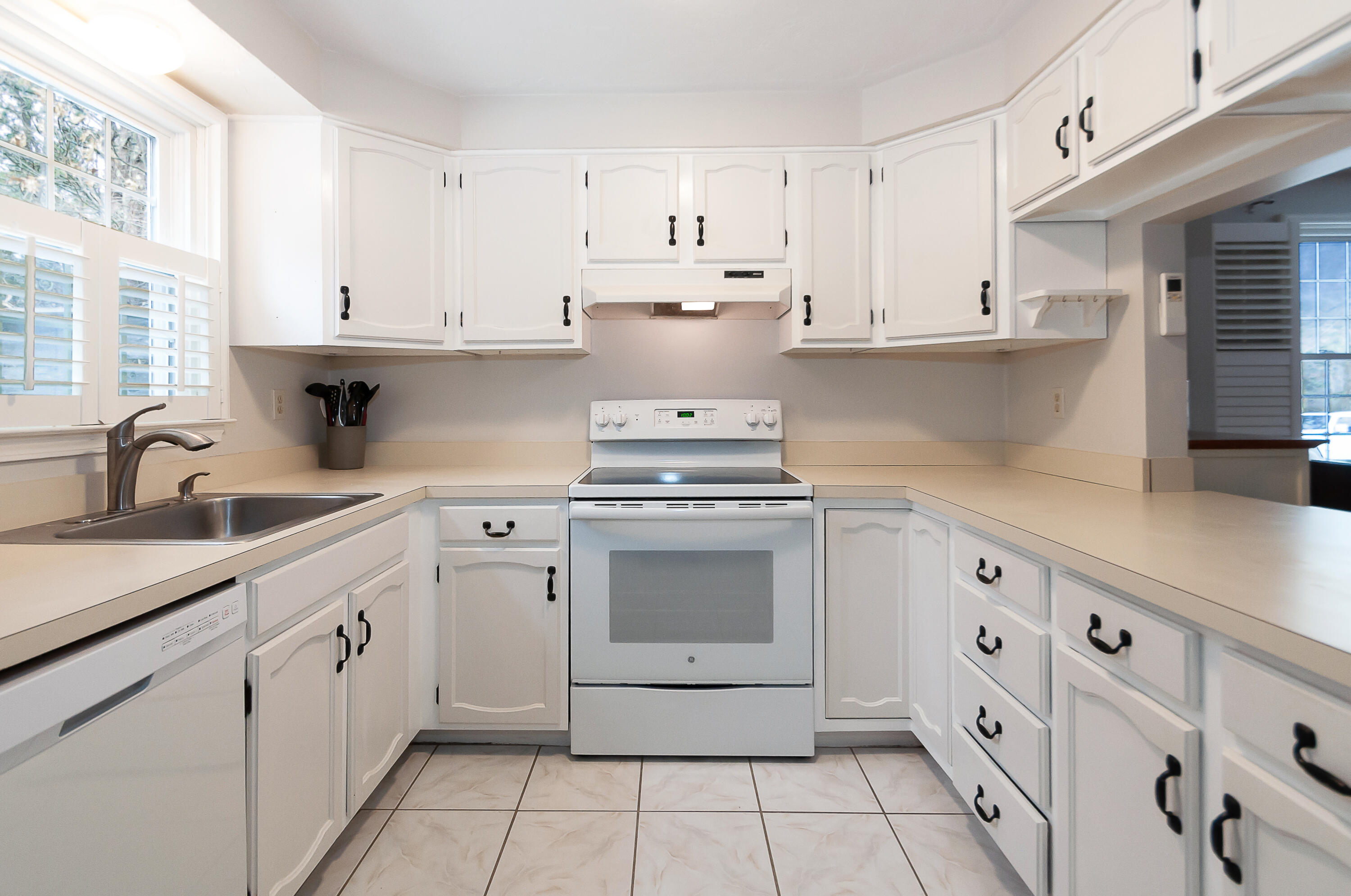 36 Atkins Road, Unit E6 East Sandwich, MA 02537 - Photo 10 of 30 a kitchen with white cabinets and appliances