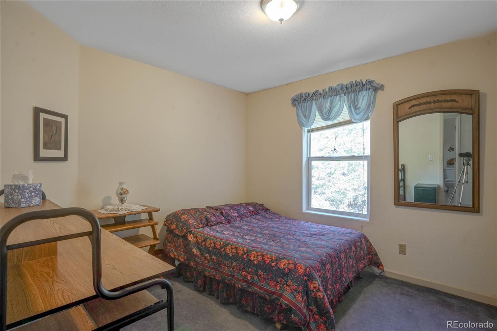 1206 Biddle Street Georgetown, CO 80444 - Photo 14 of 32 a bedroom with a bed window and with furniture