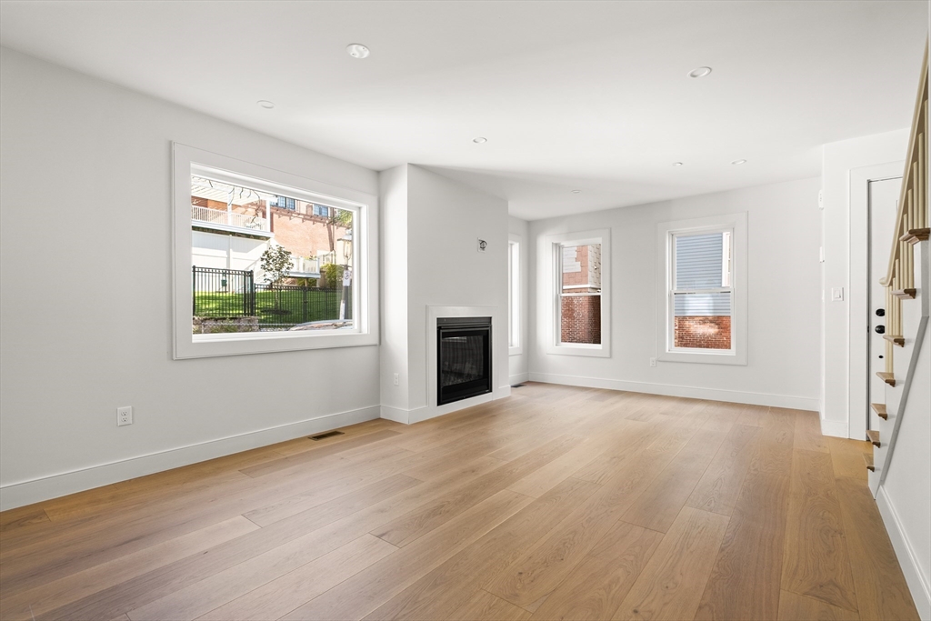 9 Armory Street Boston, MA 02129 - Photo 11 of 37 a view of an empty room with a window and wooden floor