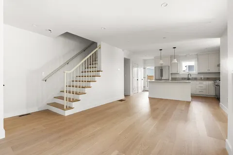 a view of kitchen with wooden floor and electronic appliances