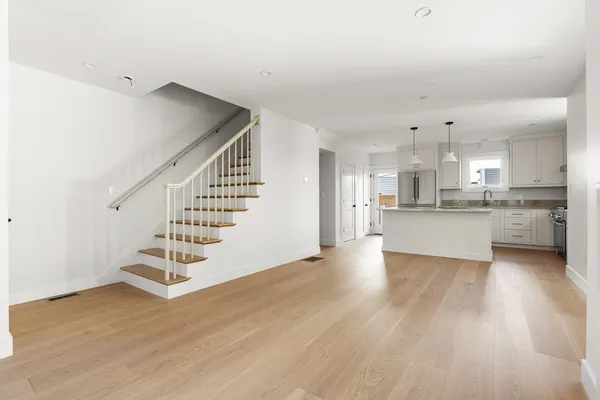 a view of kitchen with wooden floor and electronic appliances