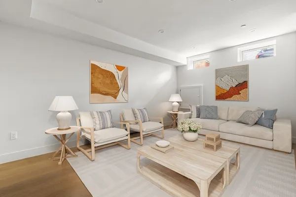 a living room with furniture and a lamp